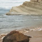 Breathtaking view of Scala dei Turchi's iconic white cliff and beach in Sicily, Italy.